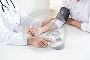 Doctor using a measuring blood pressure checking patient with examining, presenting results symptom and recommend treatment method