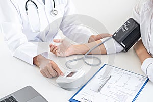 Doctor using a measuring blood pressure checking patient with examining, presenting results symptom and recommend treatment method