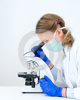 Doctor using microscope in laboratory.