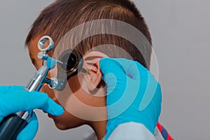doctor using ostomoscope child eye exam