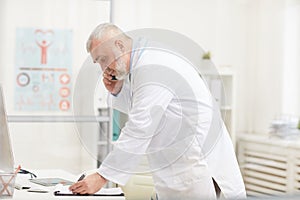 Doctor using phone in his work