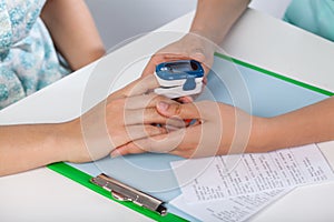 Doctor using pulse oximeter