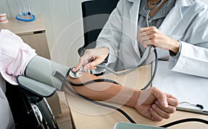 Doctor using sphygmomanometer checking blood pressure