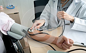 Doctor using sphygmomanometer checking blood pressure photo