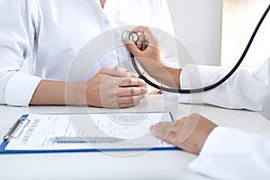 Doctor using a stethoscope checking patient with examining, presenting results symptom and recommend treatment method, Healthcare