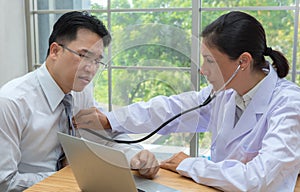 Doctor using the stethoscope listen to heartbeat of man patient