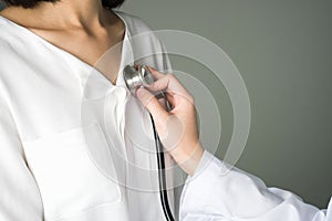 Doctor is using a stethoscope for patients patient examination.