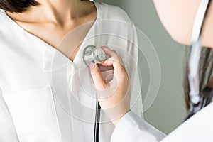 Doctor is using a stethoscope for patients patient examination. To hear the heart rate, For patients with heart disease. photo