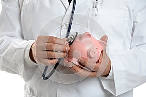 Doctor Using Stethoscope on Piggy Bank