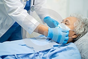 Doctor using stethoscope to checking Asian senior or elderly old lady woman patient wearing a face mask in hospital for protect