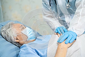 Doctor using stethoscope to checking Asian senior or elderly old lady woman patient wearing a face mask in hospital for protect