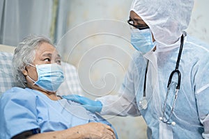 Doctor using stethoscope to checking Asian senior or elderly old lady woman patient wearing a face mask in hospital for protect