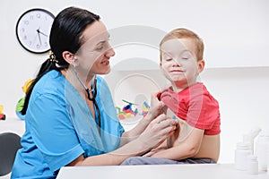 Doctor using stethoscope to examining little sweet boy