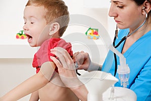 Doctor using stethoscope to examining little sweet boy