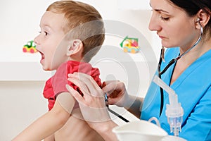 Doctor using stethoscope to examining little sweet boy