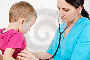 Doctor using stethoscope to examining little sweet boy