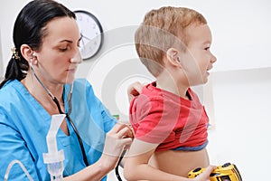 Doctor using stethoscope to examining little sweet boy
