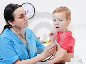 Doctor using stethoscope to examining little sweet boy