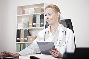 Doctor Using Tablet and Desktop Computer Together