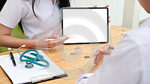 Doctor using tablet discussion something with patient