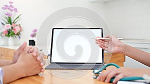 Doctor using tablet discussion something with patient