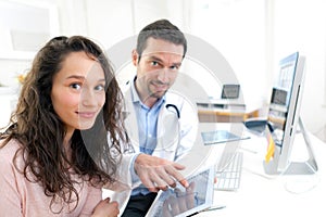 Doctor using tablet to inform patient