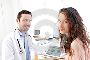 Doctor using tablet to inform patient photo