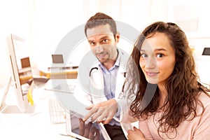 Doctor using tablet to inform patient