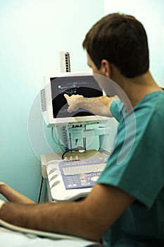 Doctor using ultrasound machine