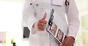 Doctor uzist or gynecologist thumbs up gesture in the clinic