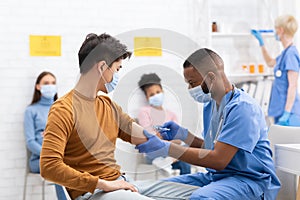 Doctor Vaccinating Asian Male Patient Giving Covid-19 Vaccine In Hospital