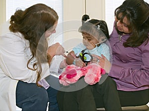 Doctor vaccinating a little Native American girl