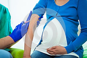 Doctor vaccinating pregnant woman