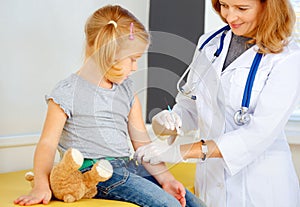 Doctor vaccinating small girl