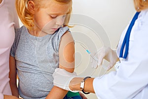 Doctor vaccinating small redhead