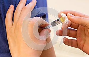 Doctor vaccinating a young woman