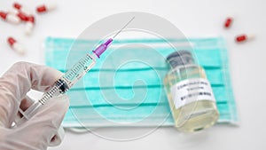 Doctor with vaccine and syringe injection for Covid19 in scientific laboratory