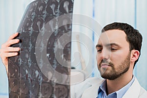 Doctor viewing MRI scans at his office