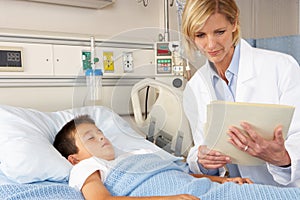 Doctor Visiting Child Patient On Ward