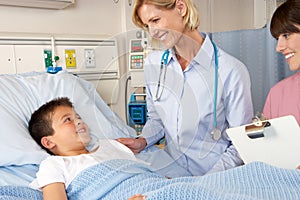 Doctor Visiting Child Patient On Ward photo