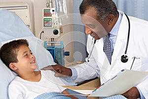 Doctor Visiting Child Patient On Ward photo