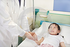 Doctor Visiting Child Patient On Ward