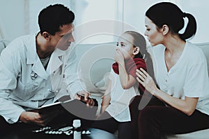 Doctor Visiting Little Girl in Red Scarf with Cold