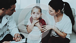 Doctor Visiting Little Girl in Red Scarf with Cold