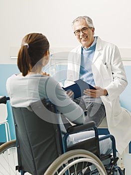 Doctor visiting a paraplegic patient at the hospital