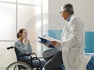 Doctor visiting a paraplegic patient at the hospital photo