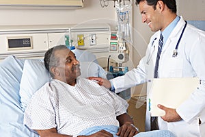 Doctor Visiting Senior Male Patient On Ward