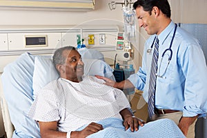 Doctor Visiting Senior Male Patient On Ward