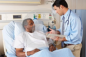 Doctor Visiting Senior Male Patient On Ward