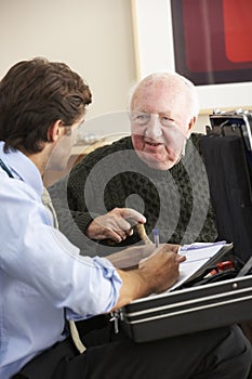 Doctor visiting senior man at home